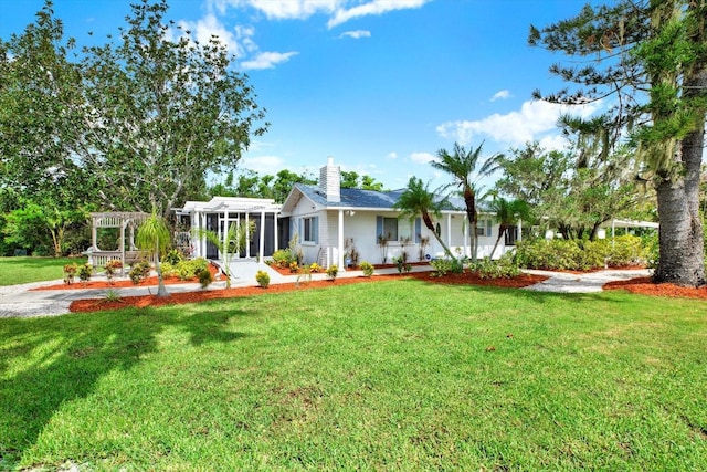 102 W N Branch Rd, Ruskin, FL 33570 - view of front of property with a sunroom, a front yard, and a chimney