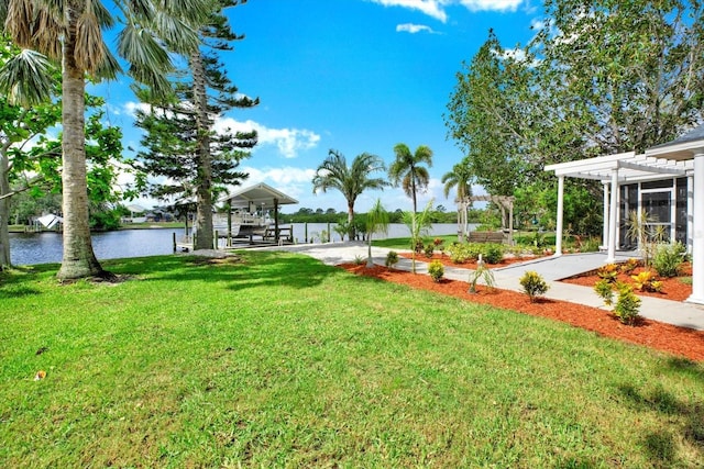 102 W N Branch Rd, Ruskin, FL 33570 - view of grassy yard featuring a pergola, a water view, and a boat dock