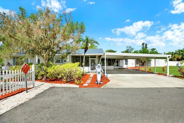 102 W N Branch Rd, Ruskin, FL 33570 - view of front of house with a sunroom, driveway, and an attached carport