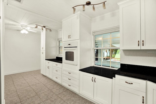 102 W N Branch Rd, Ruskin, FL 33570 - kitchen featuring oven, dark countertops, light tile patterned floors, white cabinets, and a ceiling fan