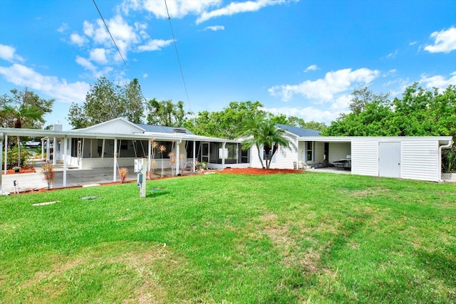 102 W N Branch Rd, Ruskin, FL 33570 - back of property featuring a sunroom and a lawn