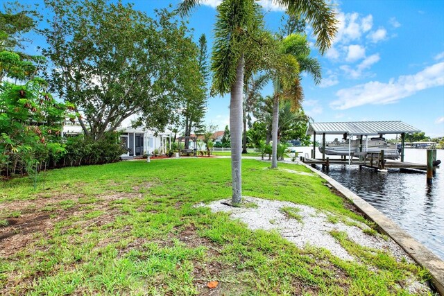 102 W N Branch Rd, Ruskin, FL 33570 - view of grassy yard featuring boat lift, a water view, and a dock