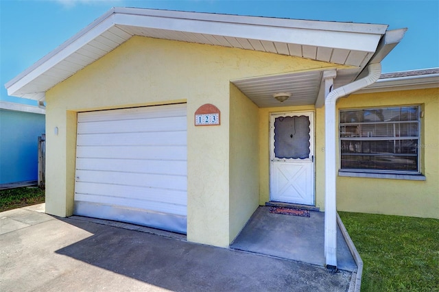 123 11th Ave, Indian Rocks Beach, FL 33785 - property entrance featuring stucco siding and a garage