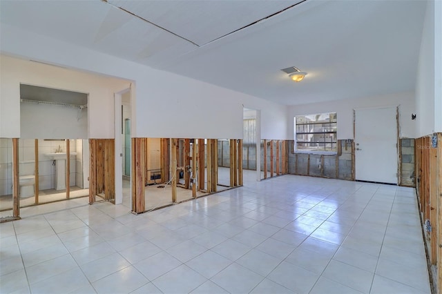 123 11th Ave, Indian Rocks Beach, FL 33785 - empty room with a wainscoted wall and tile patterned floors