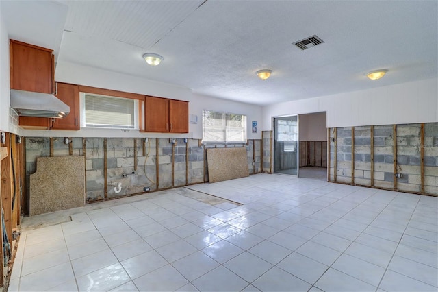 123 11th Ave, Indian Rocks Beach, FL 33785 - unfurnished room with a wainscoted wall and light tile patterned floors