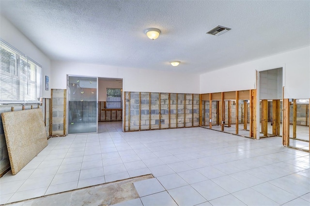 123 11th Ave, Indian Rocks Beach, FL 33785 - tiled spare room featuring a textured ceiling