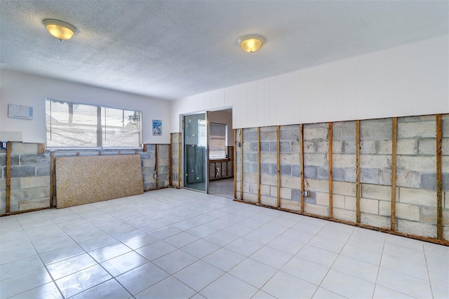 123 11th Ave, Indian Rocks Beach, FL 33785 - unfurnished room featuring a textured ceiling, wainscoting, and tile patterned flooring
