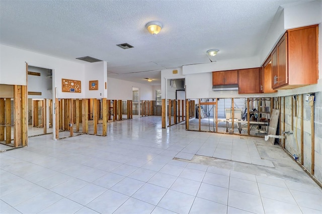 123 11th Ave, Indian Rocks Beach, FL 33785 - misc room with wainscoting, a textured ceiling, and light tile patterned floors