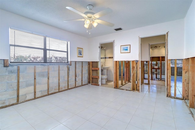 123 11th Ave, Indian Rocks Beach, FL 33785 - spare room with a wainscoted wall, ceiling fan, and tile walls