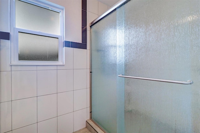 123 11th Ave, Indian Rocks Beach, FL 33785 - bathroom featuring a shower with shower door and tile walls