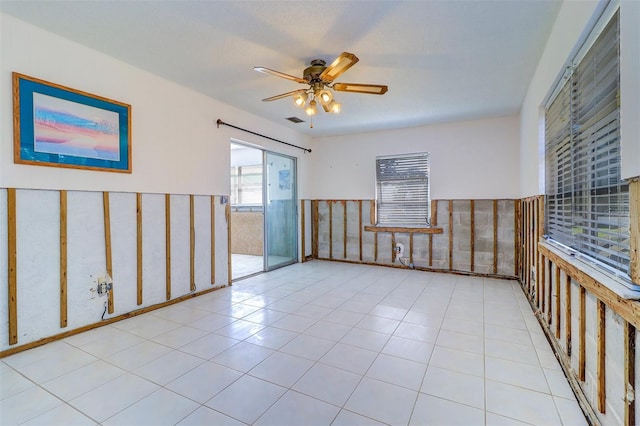 123 11th Ave, Indian Rocks Beach, FL 33785 - unfurnished room featuring wainscoting and a ceiling fan