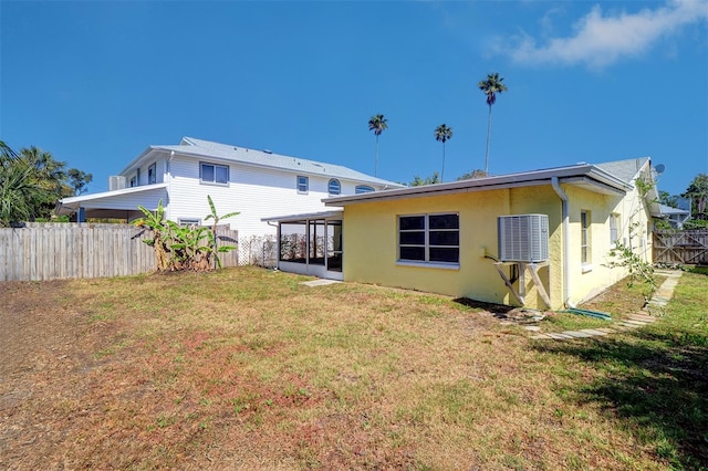 123 11th Ave, Indian Rocks Beach, FL 33785 - rear view of house featuring a sunroom and stucco siding