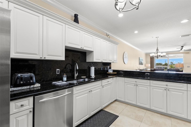 300 Capri Blvd Unit 3, Treasure Island, FL 33706 - kitchen with stainless steel appliances, a chandelier, ornamental molding, light tile patterned flooring, and decorative backsplash