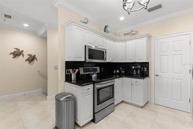 300 Capri Blvd Unit 3, Treasure Island, FL 33706 - kitchen with stainless steel appliances, ornamental molding, decorative backsplash, dark countertops, and white cabinetry