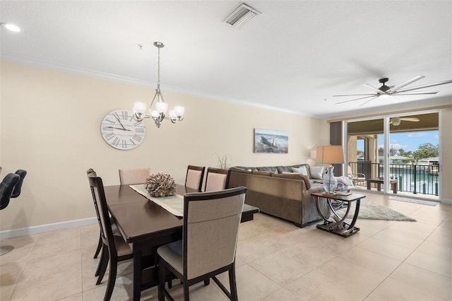 300 Capri Blvd Unit 3, Treasure Island, FL 33706 - dining area featuring crown molding, a chandelier, a ceiling fan, and light tile patterned flooring