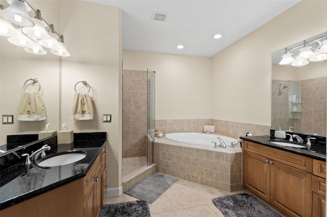 300 Capri Blvd Unit 3, Treasure Island, FL 33706 - bathroom with a shower stall, a bath, tile patterned flooring, and two vanities