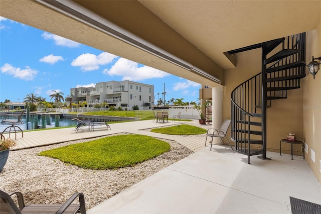 300 Capri Blvd Unit 3, Treasure Island, FL 33706 - view of patio with stairway, a residential view, and a water view