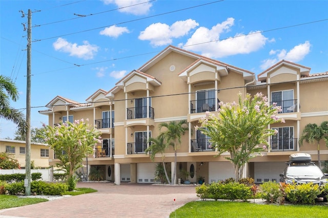 300 Capri Blvd Unit 3, Treasure Island, FL 33706 - view of apartment building / complex featuring an attached garage and driveway