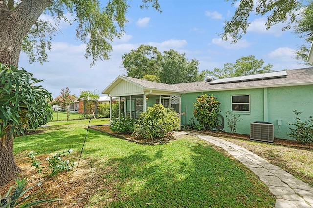 6131 17th St, Zephyrhills, FL 33542 - rear view of house with stucco siding and roof mounted solar panels