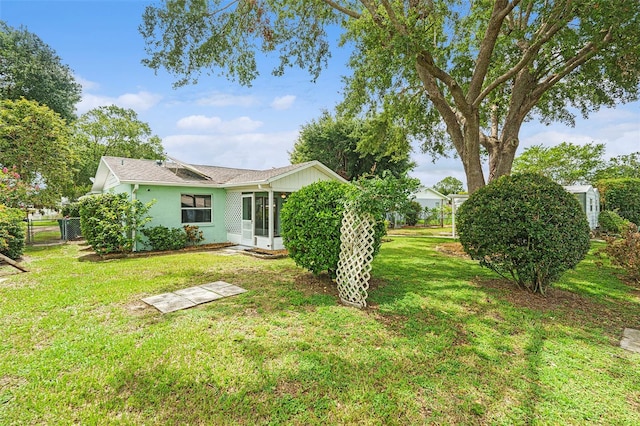 6131 17th St, Zephyrhills, FL 33542 - view of yard featuring a sunroom