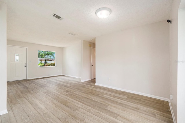 6131 17th St, Zephyrhills, FL 33542 - unfurnished room with light wood-style floors and a textured ceiling