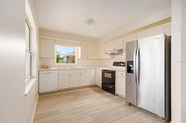 6131 17th St, Zephyrhills, FL 33542 - kitchen featuring stainless steel fridge, dishwasher, black electric range oven, light countertops, and light wood finished floors