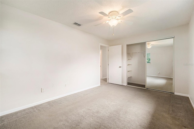 6131 17th St, Zephyrhills, FL 33542 - unfurnished bedroom with carpet, a closet, and a ceiling fan