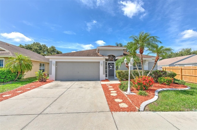 10505 Goldwater Ln, Riverview, FL 33578 - view of front facade featuring stucco siding, a garage, and concrete driveway