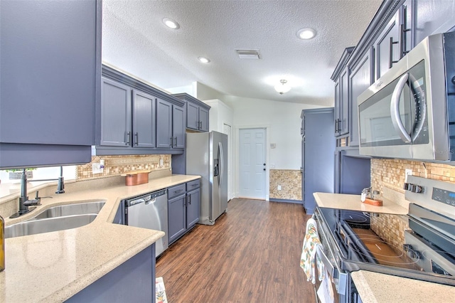 10505 Goldwater Ln, Riverview, FL 33578 - kitchen with stainless steel appliances, backsplash, dark wood-type flooring, a textured ceiling, and light stone countertops
