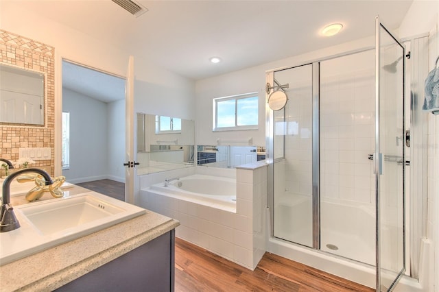 10505 Goldwater Ln, Riverview, FL 33578 - full bathroom featuring a stall shower, a bath, vanity, wood finished floors, and recessed lighting