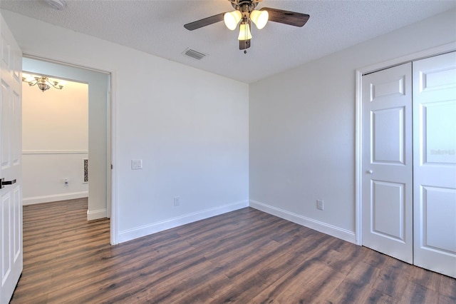10505 Goldwater Ln, Riverview, FL 33578 - unfurnished bedroom featuring dark wood-style flooring, a closet, a textured ceiling, ceiling fan, and a chandelier