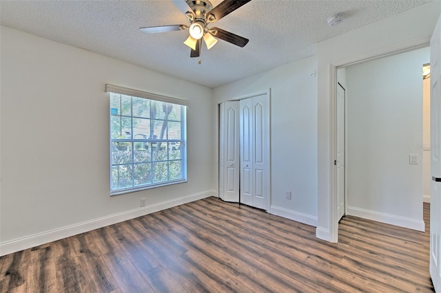 10505 Goldwater Ln, Riverview, FL 33578 - unfurnished bedroom featuring dark wood-style floors, a textured ceiling, a closet, and a ceiling fan