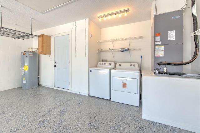 10505 Goldwater Ln, Riverview, FL 33578 - laundry room with water heater, washing machine and dryer, heating unit, and a textured ceiling