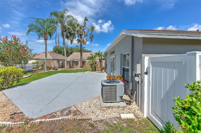 10505 Goldwater Ln, Riverview, FL 33578 - view of side of property with a fenced backyard, a patio area, and stucco siding