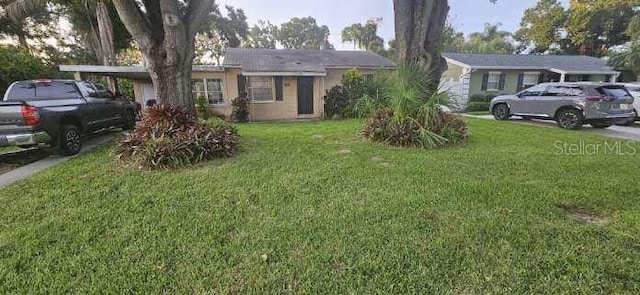 4111 W Bay Villa Ave, Tampa, FL 33611 - ranch-style home featuring a front lawn and concrete driveway