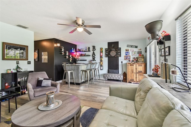 549 Walden Ct, Dunedin, FL 34698 - living area with a bar, a ceiling fan, and wood finished floors