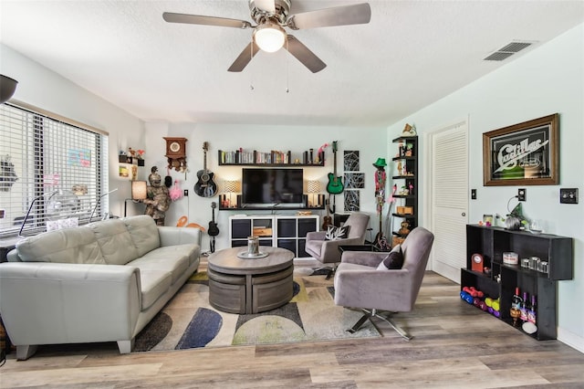 549 Walden Ct, Dunedin, FL 34698 - living room featuring wood finished floors, a ceiling fan, and a textured ceiling