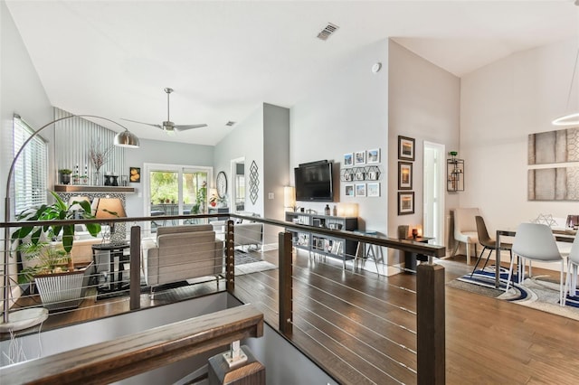 549 Walden Ct, Dunedin, FL 34698 - kitchen with wood finished floors, ceiling fan, open floor plan, and a towering ceiling