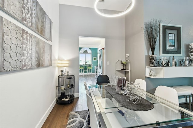 549 Walden Ct, Dunedin, FL 34698 - dining space featuring wood finished floors and a towering ceiling