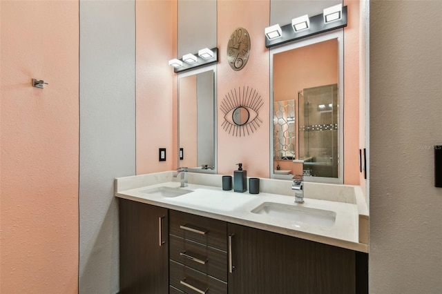 549 Walden Ct, Dunedin, FL 34698 - bathroom featuring double vanity, a textured wall, and an enclosed shower