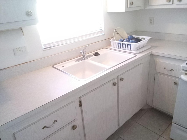 390 301st Blvd W Unit 8D, Bradenton, FL 34205 - kitchen featuring light countertops, white cabinets, and tile patterned flooring