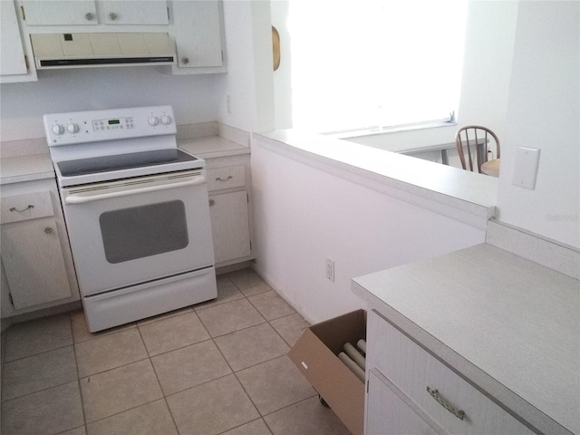 390 301st Blvd W Unit 8D, Bradenton, FL 34205 - kitchen with white electric stove, range hood, light countertops, and light tile patterned floors