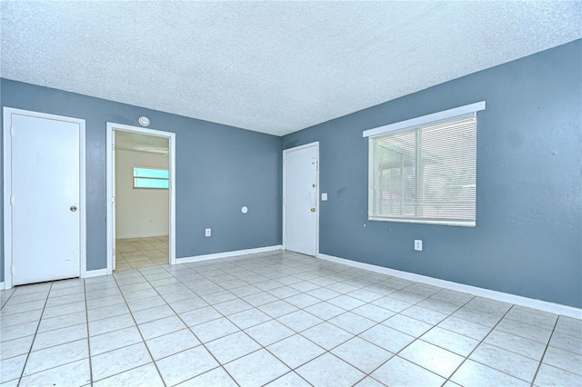 37740 Waverly Ave, Zephyrhills, FL 33542 - spare room with a textured ceiling and light tile patterned floors