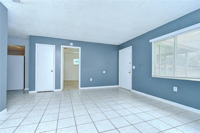 37740 Waverly Ave, Zephyrhills, FL 33542 - unfurnished room with a textured ceiling and light tile patterned floors