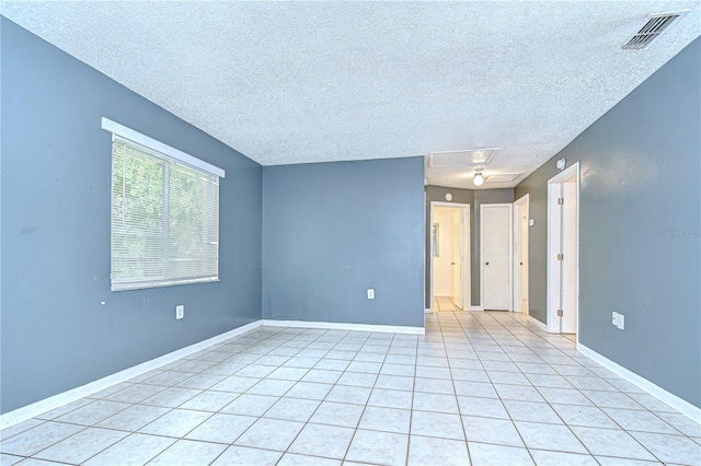37740 Waverly Ave, Zephyrhills, FL 33542 - empty room with a textured ceiling and light tile patterned floors