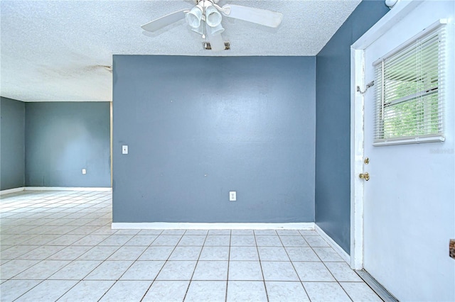 37740 Waverly Ave, Zephyrhills, FL 33542 - spare room with a textured ceiling, light tile patterned flooring, and a ceiling fan