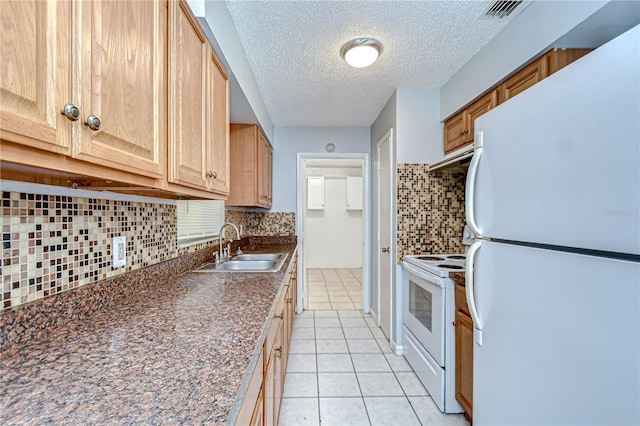 37740 Waverly Ave, Zephyrhills, FL 33542 - kitchen featuring white appliances, dark countertops, decorative backsplash, a textured ceiling, and light tile patterned floors