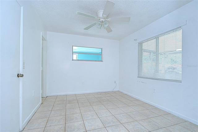 37740 Waverly Ave, Zephyrhills, FL 33542 - empty room featuring a textured ceiling, a ceiling fan, and light tile patterned floors