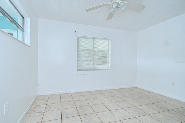 37740 Waverly Ave, Zephyrhills, FL 33542 - empty room with plenty of natural light, ceiling fan, light tile patterned flooring, and a textured ceiling