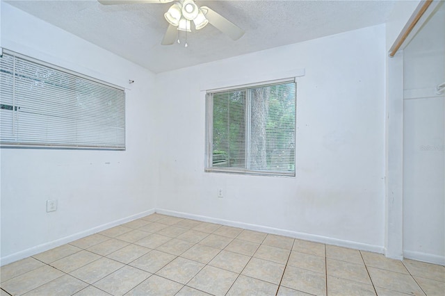 37740 Waverly Ave, Zephyrhills, FL 33542 - empty room with a ceiling fan, light tile patterned floors, and a textured ceiling
